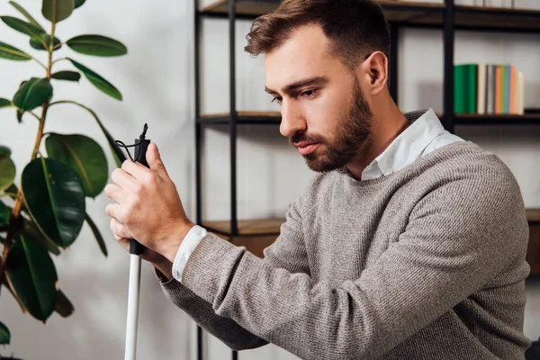 Upset blind man with walking stick in living room — Stock Photo