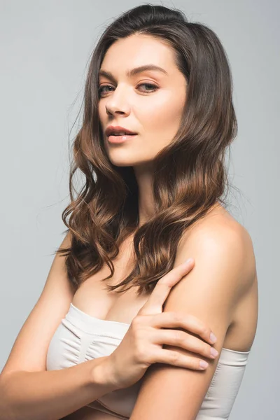 Portrait of tender brunette woman with clean skin, isolated on grey — Stock Photo