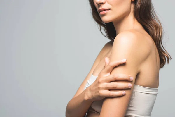 Cropped view of attractive brunette woman with clean skin, isolated on grey — Stock Photo