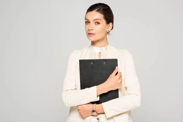Empresária confiante em terno branco segurando prancheta, isolado em cinza — Fotografia de Stock