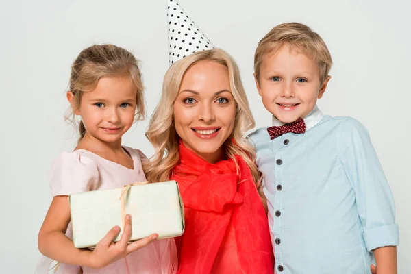 Beautiful, happy woman with son and daughter smiling at camera isolated on grey — Stock Photo