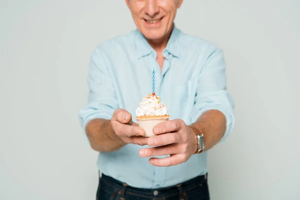 Cropped view of smiling senior man holding gift boxes isolated on grey — Stock Photo