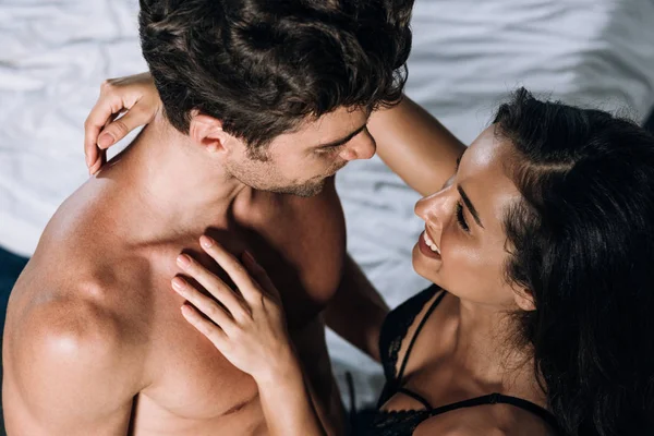 Happy, sensual woman embracing shirtless, sexy boyfriend — Stock Photo