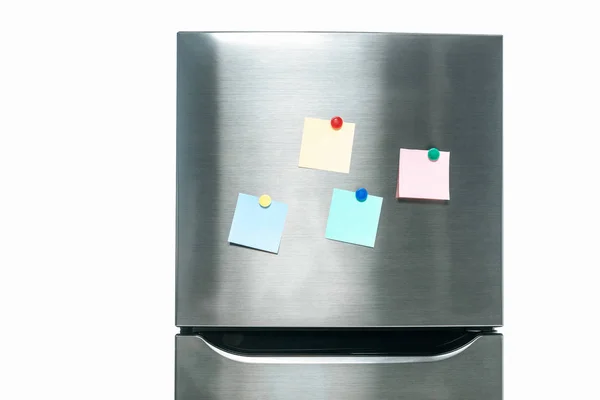 Stainless steel fridge with blank sticky notes on freezer isolated on white — Stock Photo