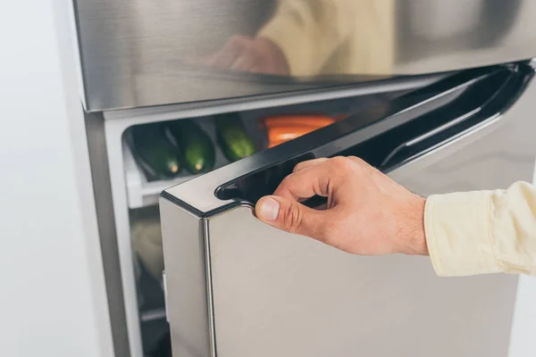 Cropped view of man open fridge door — Stock Photo