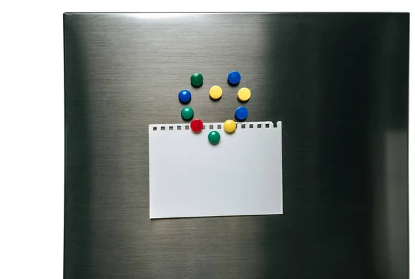 Papier vide accroché sur réfrigérateur en acier inoxydable avec des aimants disposés en coeur isolé sur blanc — Photo de stock