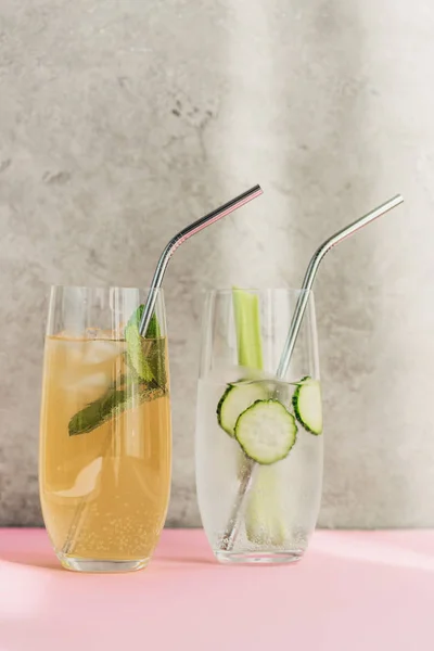 Fresh lemonade with ice, mint, celery, straw and cucumber slices in sunlight — Stock Photo