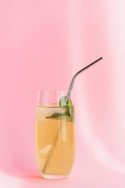 Limonade fraîche avec glace, paille et menthe au soleil sur fond rose — Photo de stock