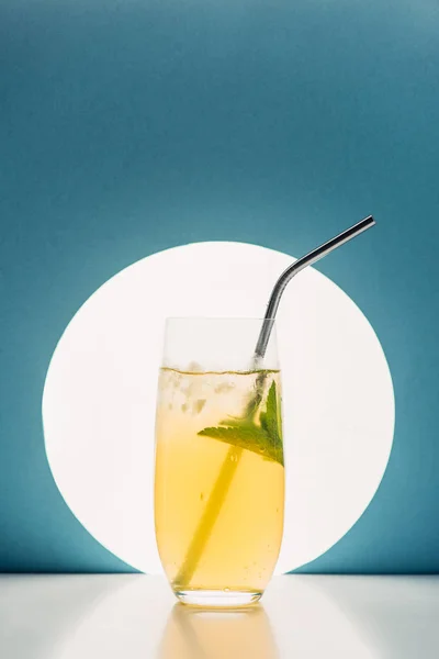 Frische Limonade mit Minze und Stroh auf blauem Hintergrund mit Gegenlicht — Stockfoto