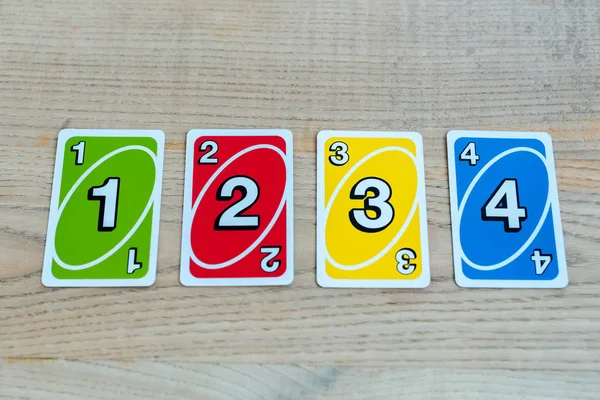 KYIV, UKRAINE - NOVEMBER 22, 2019: top view of uno playing cards on wooden table — Stock Photo