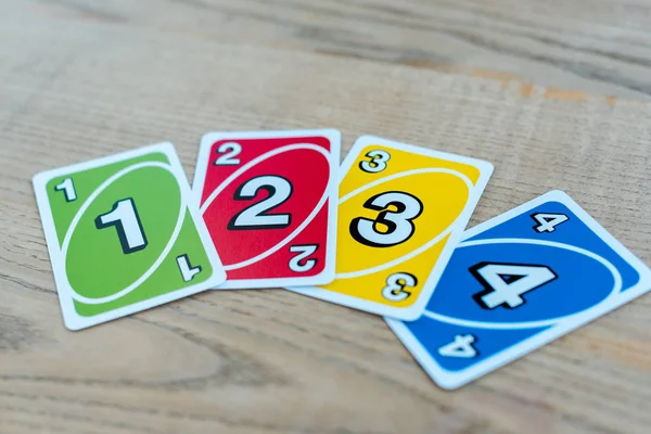 KYIV, UKRAINE - NOVEMBER 22, 2019: selective focus of uno playing cards on wooden table — Stock Photo