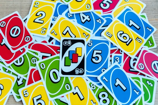 KYIV, UKRAINE - NOVEMBER 22, 2019: top view of uno playing cards on wooden desk — Stock Photo