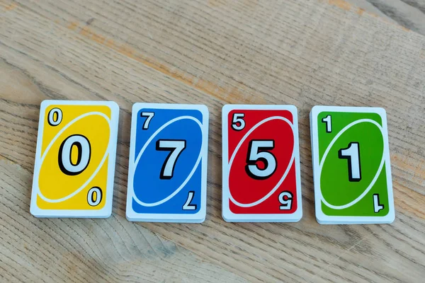 KYIV, UKRAINE - NOVEMBER 22, 2019: top view of uno playing cards with numbers on wooden table — Stock Photo