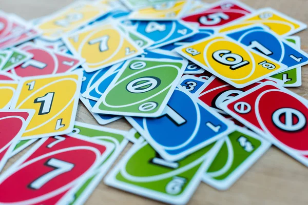 KYIV, UKRAINE - NOVEMBER 22, 2019: selective focus of uno playing cards on wooden table — Stock Photo