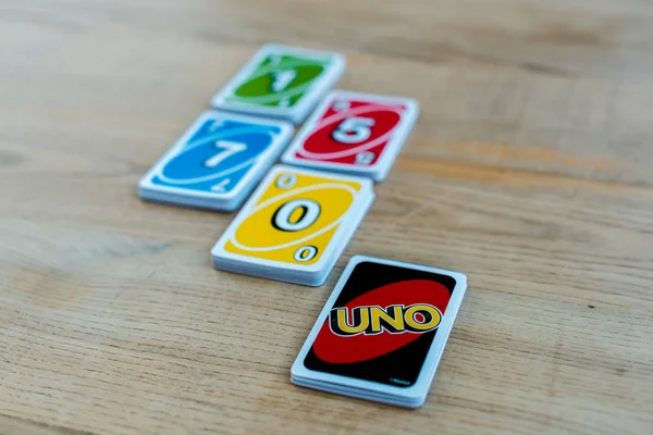 KYIV, UKRAINE - NOVEMBER 22, 2019: selective focus of uno letters near playing cards on wooden table — Stock Photo