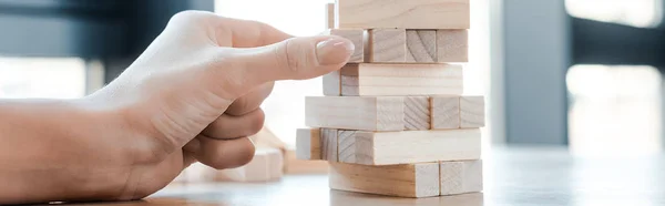 KYIV, UKRAINE - NOVEMBER 22, 2019: panoramic shot of woman playing blocks wood tower game — Stock Photo