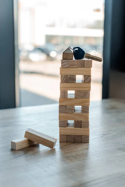 KYIV, UKRAINE - NOVEMBER 22, 2019: blocks wood tower game with key on top — Stock Photo