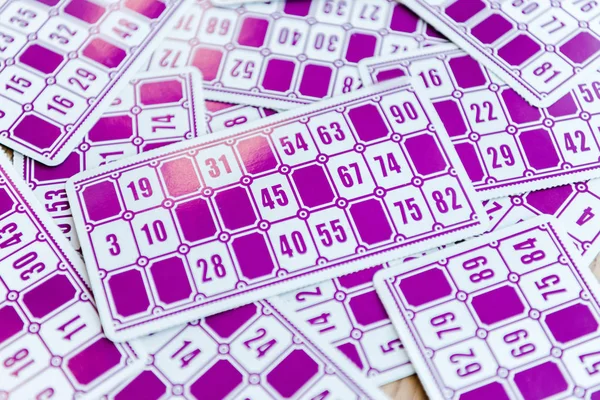 Top view of purple lottery tickets with numbers on surface — Stock Photo