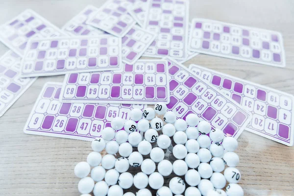 Selective focus of balls with numbers in glass near lottery tickers — Stock Photo