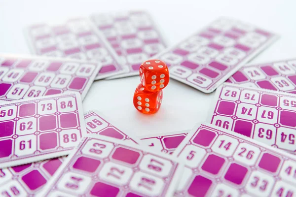 Selective focus of red dice near lottery tickets isolated on white — Stock Photo