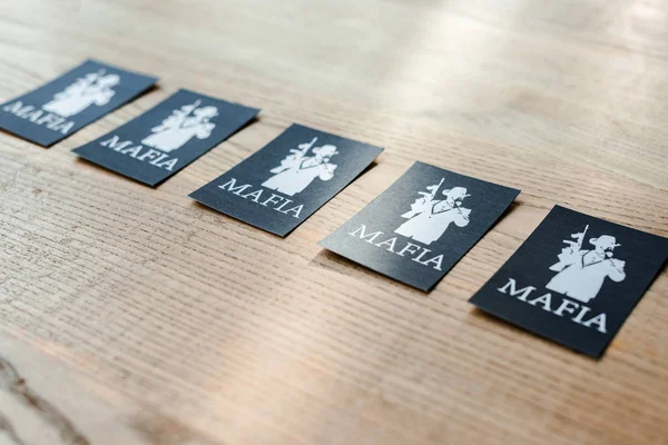 KYIV, UKRAINE - NOVEMBER 22, 2019: selective focus of playing cards with mafia letters on desk — Stock Photo
