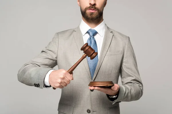 Cropped view of judge holding gavel isolated on grey — Stock Photo