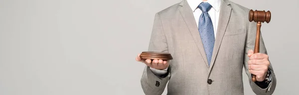 Partial view of judge holding gavel isolated on grey, panoramic shot — Stock Photo