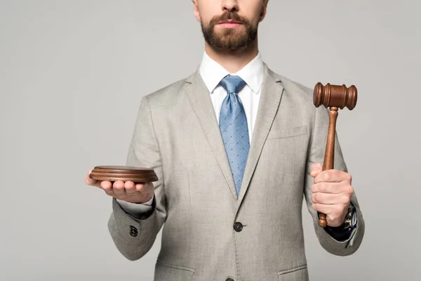 Cropped view of judge holding gavel isolated on grey — Stock Photo