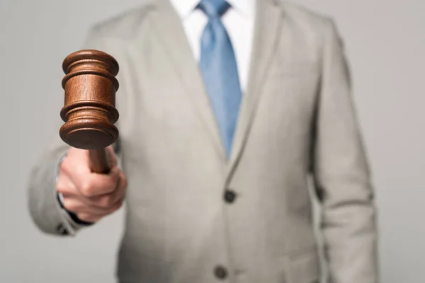 Cropped view of judge holding gavel isolated on grey — Stock Photo