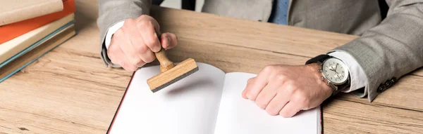 Cropped view of lawyer putting stamp in notebook isolated on grey, panoramic shot — Stock Photo