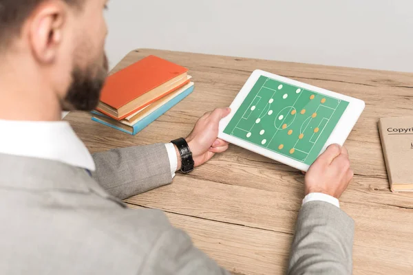 Cropped view of businessman playing football video game on laptop isolated on grey — Stock Photo