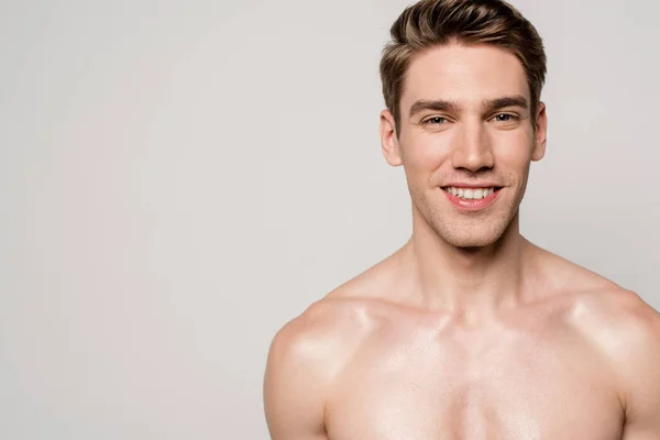 Lächeln sexy Mann mit muskulösem Oberkörper isoliert auf grau — Stockfoto