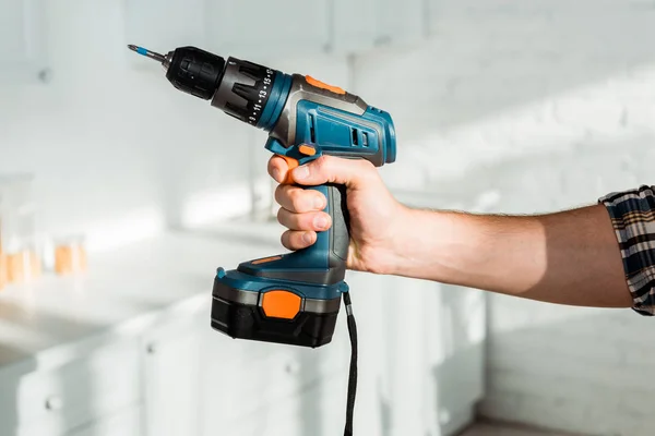 Cropped view of installer holding hammer drill in hand — Stock Photo