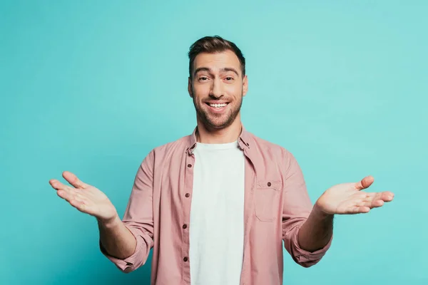 Surprised cheerful man gesturing isolated on blue — Stock Photo