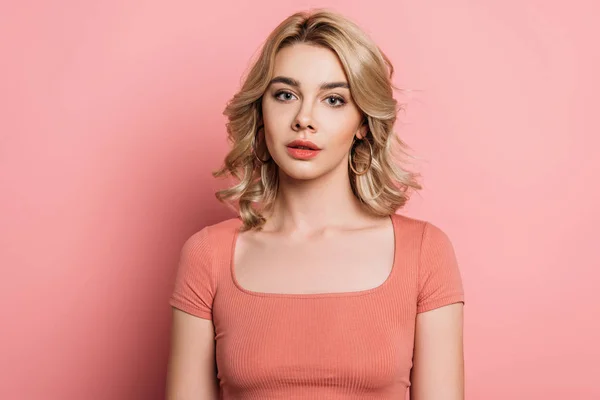 Beautiful, dreamy girl looking at camera on pink background — Stock Photo