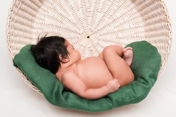 Adorable newborn mixed race baby sleeping in basket on white — Stock Photo