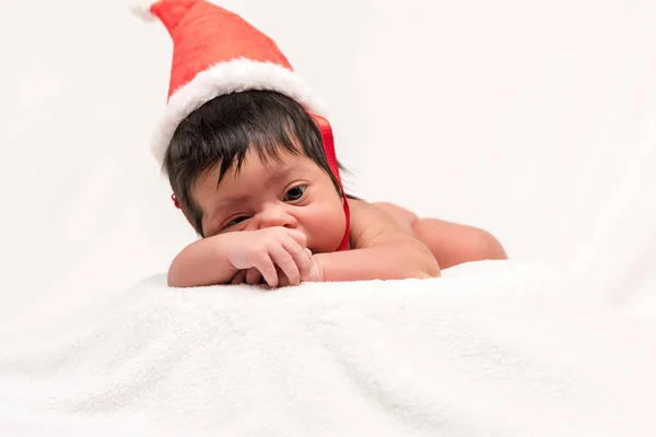 Adorable mixed race newborn baby in santa hat isolated on white — Stock Photo