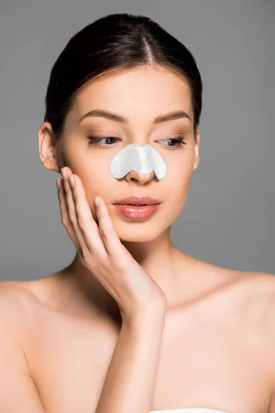 Attractive girl with patch on nose, isolated on grey — Stock Photo