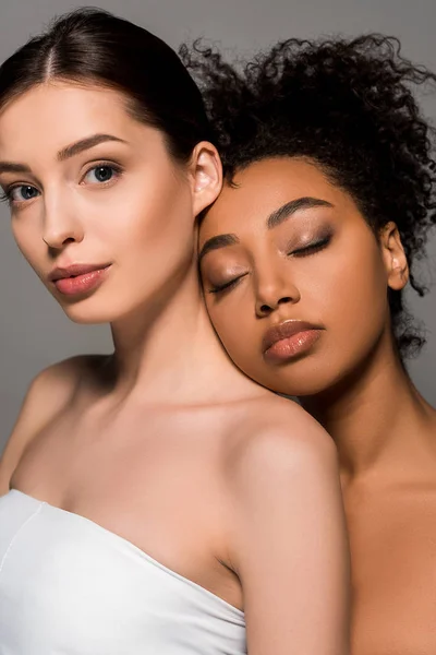 Portrait of tender multicultural women with perfect skin, isolated on grey — Stock Photo