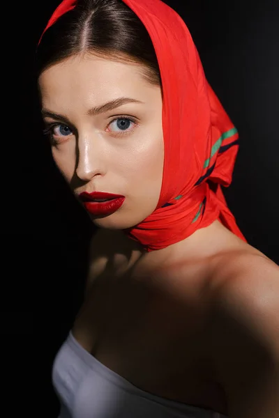 Stylish naked woman with red scarf, isolated on black — Stock Photo