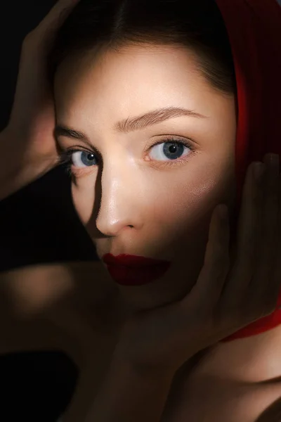 Stylish beautiful elegant girl with red scarf, isolated on black — Stock Photo