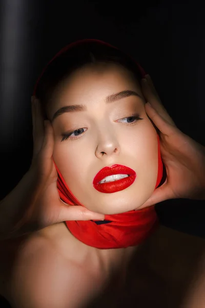 Portrait of fashionable beautiful elegant girl with red scarf, isolated on black — Stock Photo