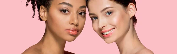 Panoramic shot of attractive multicultural girls with clean skin, isolated on pink — Stock Photo