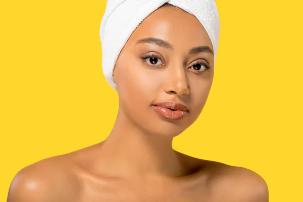Portrait of african american girl with towel on head, isolated on yellow — Stock Photo