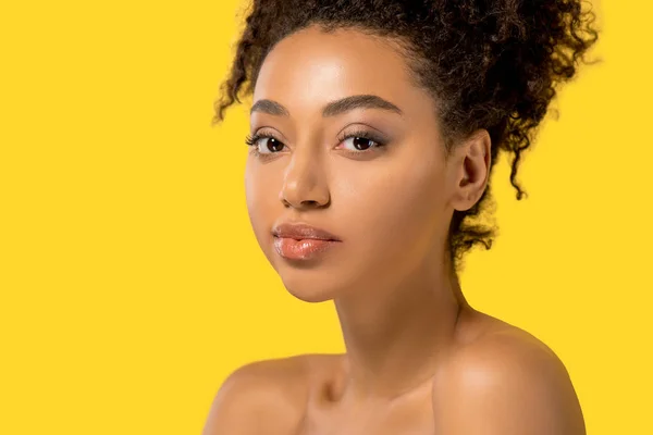 Portrait of attractive african american girl with clean skin, isolated on yellow — Stock Photo