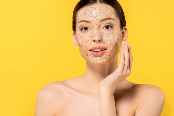 Retrato de jovem mulher nua aplicando máscara, isolado em amarelo — Fotografia de Stock