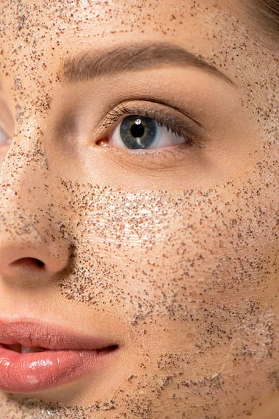 Close up of attractive young woman with peeling mask, isolated on yellow — Stock Photo