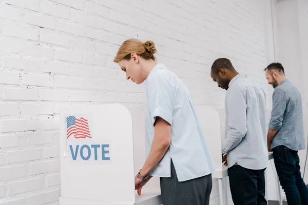 Selective focus of multicultural citizens voting near brick wall — Stock Photo