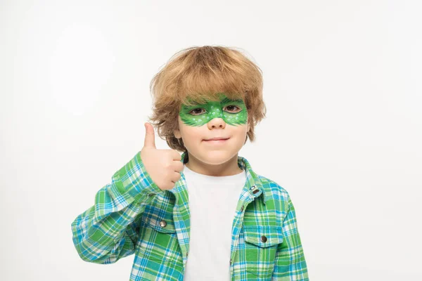 Cheerful boy with gecko mask painted on face showing thumb up while looking at camera isolated on white — Stock Photo