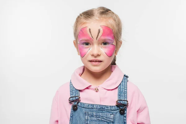 Pensive child with butterfly painting on face looking at camera isolated on white — Stock Photo